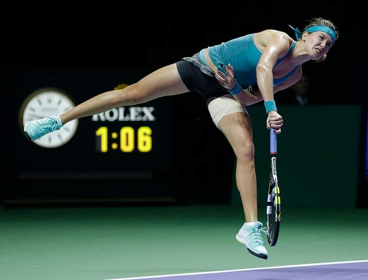 Canada's Eugenie Bouchard serves to Serbia's Ana Ivanovic during their singles match at the WTA tennis finals in Singapore,Wednesday, Oct. 22, 2014.