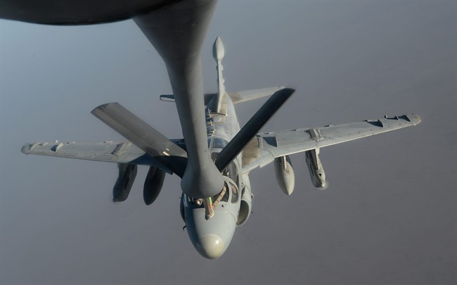 In this Saturday, Oct. 4, 2014 photo, released by the U.S. Air Force, a U.S. Navy EA-6B Prowler supporting operations against the militant Islamic State group, receives fuel from a KC-135 Stratotanker over Iraq.