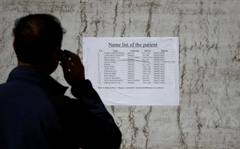 Nepalese trekking agent stands in front a patient’s list at the Army hospital in Katmandu, Nepal, Thursday, Oct. 16, 2014. THE CANADIAN PRESS/AP, Niranjan Shrestha).