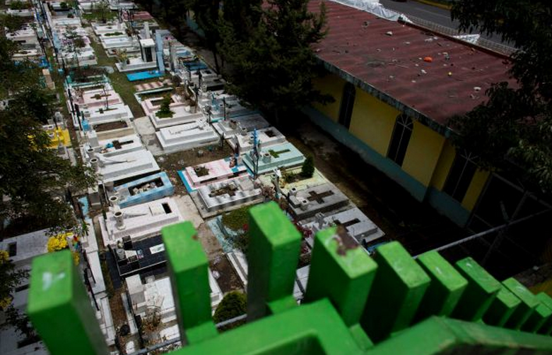 In this Sept. 12, 2014 photo, graves lie tightly packed together in a nearly-full San Isidro cemetery in northern Mexico City. Officials say there is no room available in the capital for new cemeteries. Mexico’s capital is rapidly running out of gravesites and many residents of this growing metropolis of 9 million people have to exhume the remains of their loved ones once the burial rights expire to make room for new bodies. (AP Photo/Rebecca Blackwell)
.