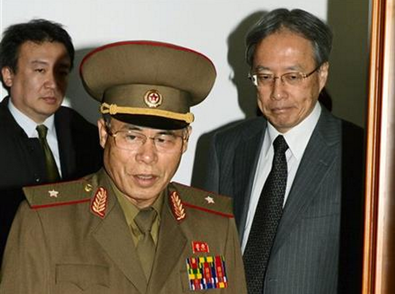 So Tae Ha, center, chairman of North Korea's Investigation Committee, center, and Junichi Ihara, right, Japan's director-general of the Asia and Oceania Affairs Bureau enter a meeting room in Pyongyang, North Korea, Tuesday, Oct. 28, 2014. Japanese and North Korean officials held talks in Pyongyang for the first time in 10 years Tuesday, meeting to assess progress into North Korea's investigation into the fates of Japanese citizens who were abducted in the 1970s and 80s. 