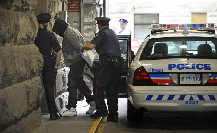 The suspect in the deadly weekend shooting at the Eaton Centre in Toronto arrives at Old City Hall courts in a police squad car on June 4 2012.