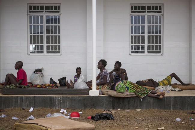 Ebola patients lie outside Port Loko District Hospital in Port Loko, Sierra Leone on Friday, Oct. 3, 2014.