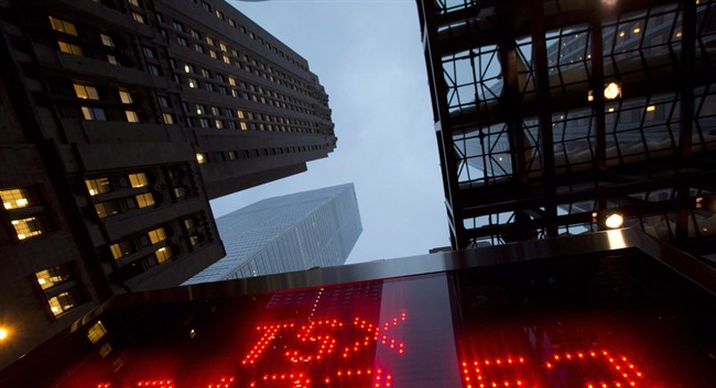 A tote board shows TSX numbers in Toronto.