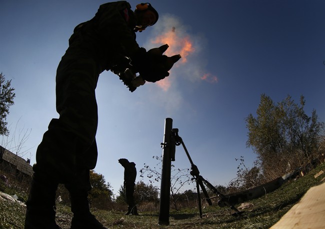 Pro-Russian rebels fire mortars toward Ukrainian positions near to the airport in the town of Donetsk, Ukraine, Thursday, Oct. 9, 2014. 