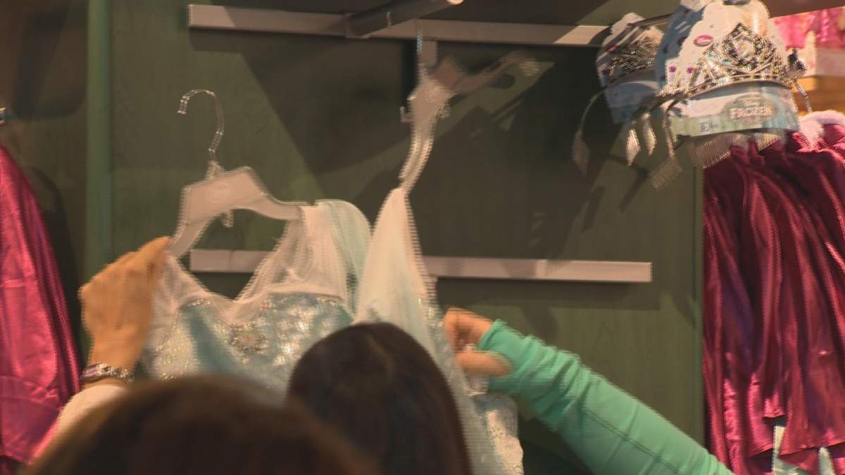 Customers in the Disney Store grab for costumes