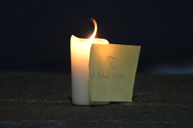 A candle and note with the name of slain reservist Nathan Cirillo of Hamilton, Ont., shown on the curb of a road near the National War Memorial in Ottawa on Wednesday, Octobe 22, 2014.