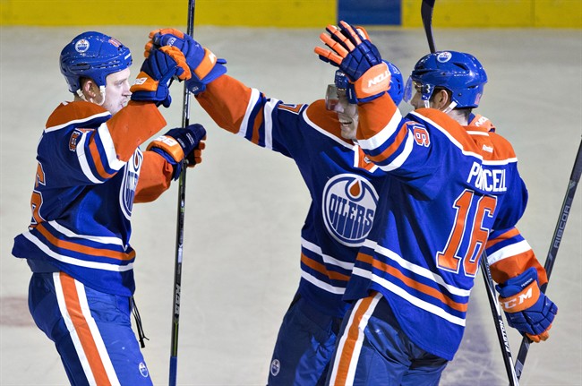 dmonton Oilers' Nikita Nikitin (86), David Perron (57) and Teddy Purcell (16) celebrate a goal against the Washington Capitals during second period NHL hockey action in Edmonton, Alta., on Wednesday October 22, 2014.