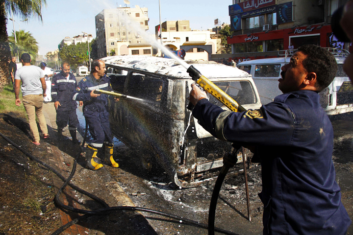 Supporters of Muslim Brotherhood and ousted president Mohammed Morsi burn police car, Cairo, Egypt - 24 Oct 2014
