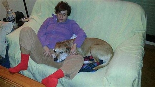 This is an undated image released on Wednesday Oct. 8, 2014 by animal rights organisation PACMA, of Teresa Romero, the nursing assistant who is infected with Ebola in Madrid, with her dog named Excalibur.
