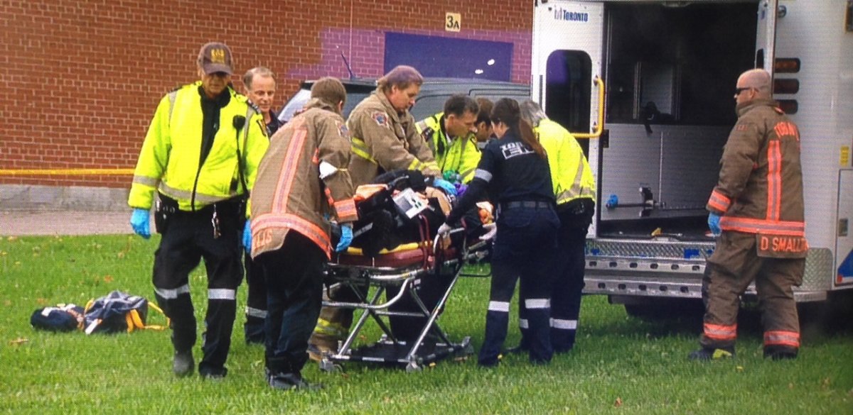 One of two victims is loaded into an ambulance after a shooting near an Etobicoke high school.