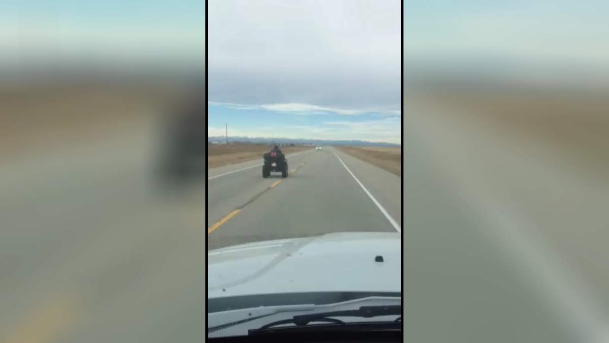 Quad driving dangerously down Deerfoot Trail. 