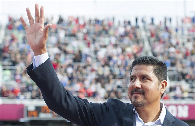Former Montreal Alouettes quarterback Anthony Calvillo waves to fans in Montreal, Monday, October 13, 2014, prior to a ceremony to retire his jersey
