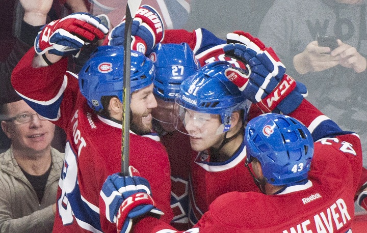 Montreal Canadiens' Alex Galchenyuk (27) celebrates with teammates Brandon Prust (8), Lars Eller (81) and Mike Weaver (43) after scoring against the Colorado Avalanche during second period NHL hockey action in Montreal, Saturday, October 18, 2014.