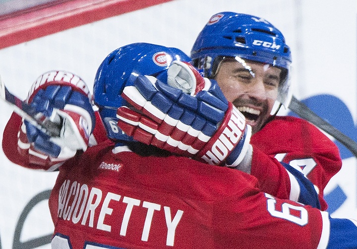 Montreal Canadiens' Tomas Plekanec, right, celebrates with teammate Max Pacioretty after scoring against the New York Rangers during first period NHL hockey action in Montreal, Saturday, October 25, 2014.