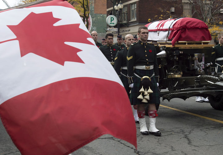 The coffin of Cpl. Nathan Cirillo is towed on a gun carriage during his funeral procession in Hamilton, Ont. on Tuesday October 28, 2014. THE CANADIAN PRESS/Frank Gunn.