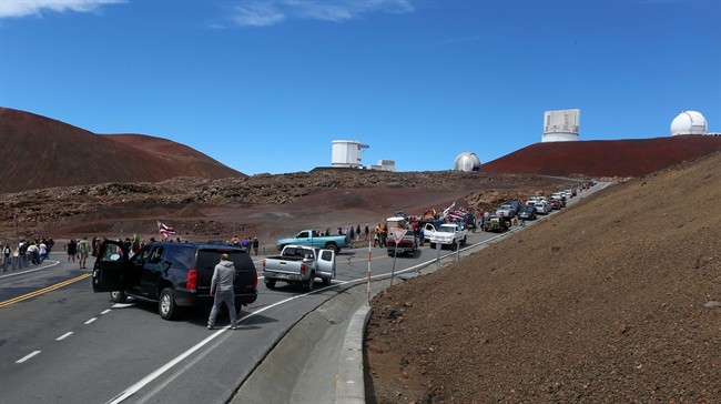 Protesters block vehicles from getting to the Thirty Meter Telescope groundbreaking ceremony site at Mauna Kea, Hawaii on Tuesday, Oct. 7, 2014.