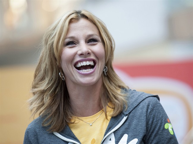 Former Olympian Catriona Le May Doan laughs during the announcement of the route for the Toronto 2015 Pan Am Torch Relay at the Eaton Centre in Toronto on Wednesday, Oct. 1, 2014.