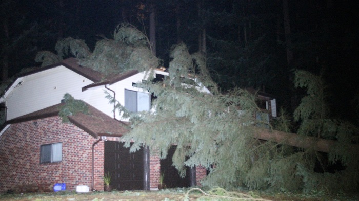 A storm battering the Lower Mainland has caused massive power outages for over 50,00 customers, and damage to several homes - including this home on Highway 10 in Surrey.