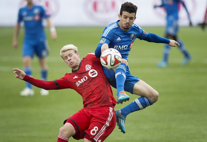 Toronto FC's Kyle Bekker, left, and Montreal Impact's Felipe Martins battle for the ball during the second half of MLS soccer action in Toronto on Saturday, October 18, 2014.