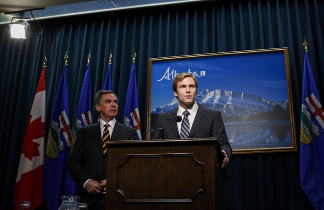 Alberta Premier Jim Prentice, left, and New Brunswick Premier Brian Gallant hold a joint news conference in Calgary on Oct. 20, 2014.
