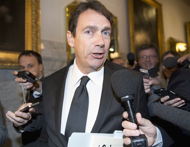 Quebec Opposition MNA Pierre Karl Péladeau responds to reporters questions as he enters a caucus meeting, Tuesday, Oct. 28, 2014.
