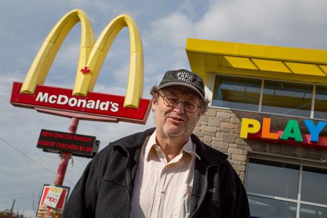 Ron Morais, who found a mouse in his McDonalds coffee, poses for a photo in front of the restaurant where it was purchased in Fredericton, Wednesday, Oct.15, 2014. THE CANADIAN PRESS/Keith Minchin.