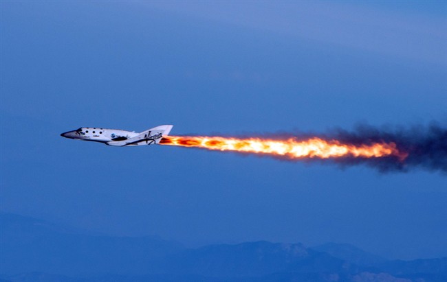 In this April 29, 2013 file photo provided by Virgin Galactic shows Virgin Galactic's SpaceShipTwo under rocket power, over Mojave, Calif.