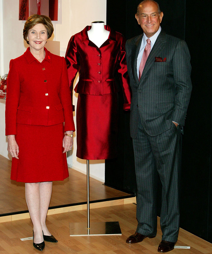 First lady Laura Bush and Oscar de la Renta attend a ceremony unveiling an Oscar de la Renta dress donated to the Spring Fashion 2004 Heart Of Truth Campaign on February 9, 2004 in New York City.