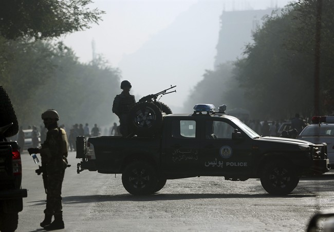 Afghan security forces guard the site of a suicide attack in Kabul, Afghanistan, Wednesday, Oct. 1, 2014. 