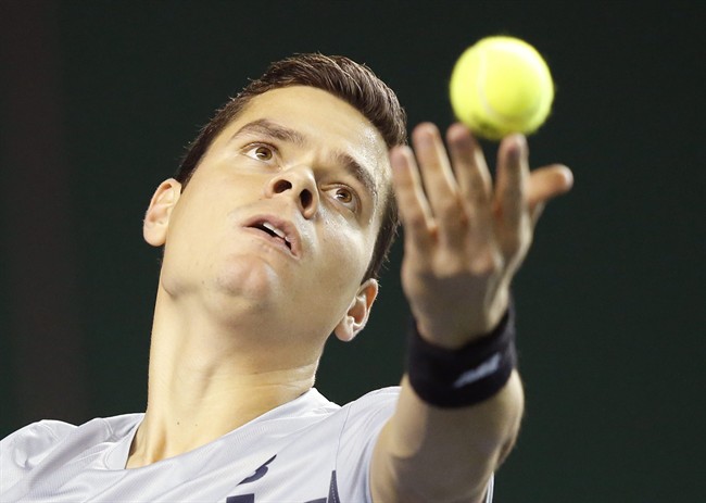 Milos Raonic serves the ball to Jack Sock during their first round match at the ATP World Tour Masters tennis tournament at Bercy stadium in Paris, France, Wednesday, Oct. 29, 2014. 