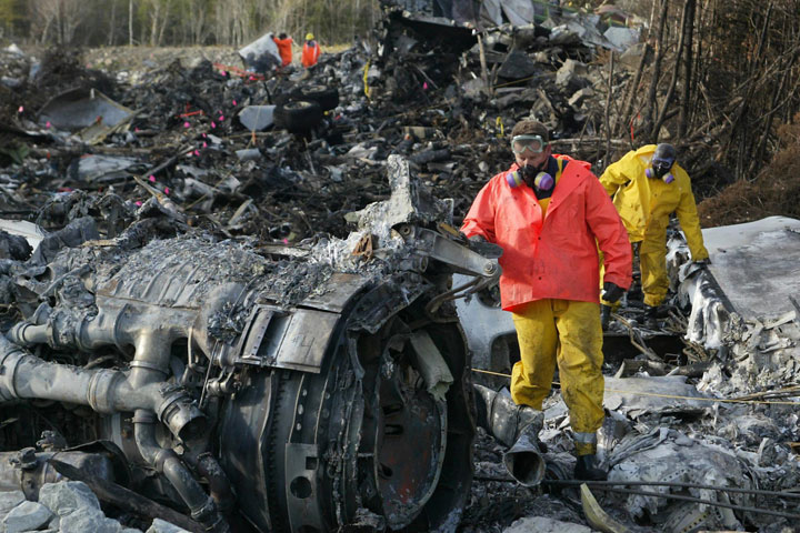 Investigators work in the debris field at the crash site of the MK Airlines 747 cargo jet near Halifax International Airport on Oct. 21, 2004. 