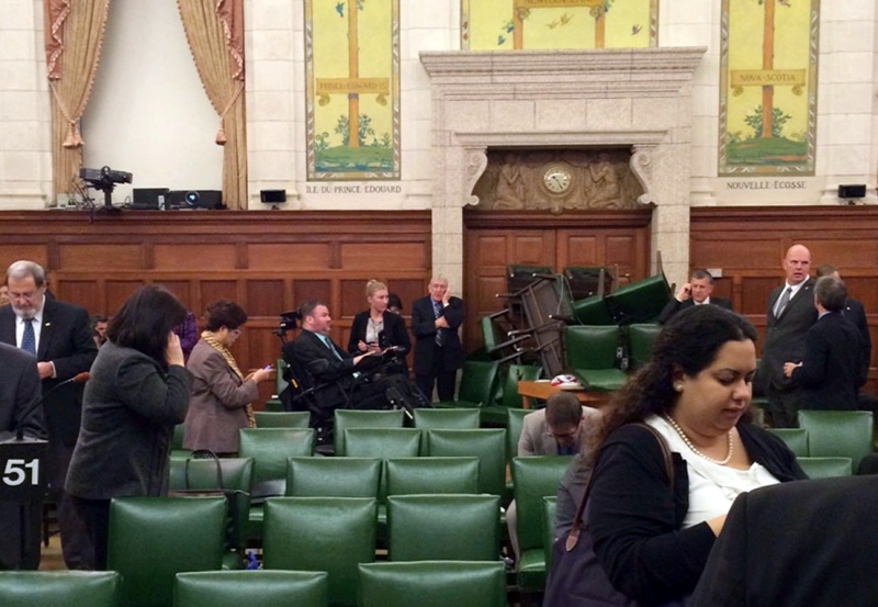 In this photo provided by Conservative MP Nina Grewal, members of Parliament barricade themselves in a meeting room on Parliament Hill in Ottawa, Canada, Wednesday, Oct. 22, 2014, after shots were fired in the building.