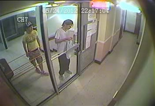 Luka Magnotta (right) is seen entering his Montreal apartment building the night of May 24, 2012 accompanied by Chinese student Jun Lin in a framegrab from a video released at the Magnotta trial. 