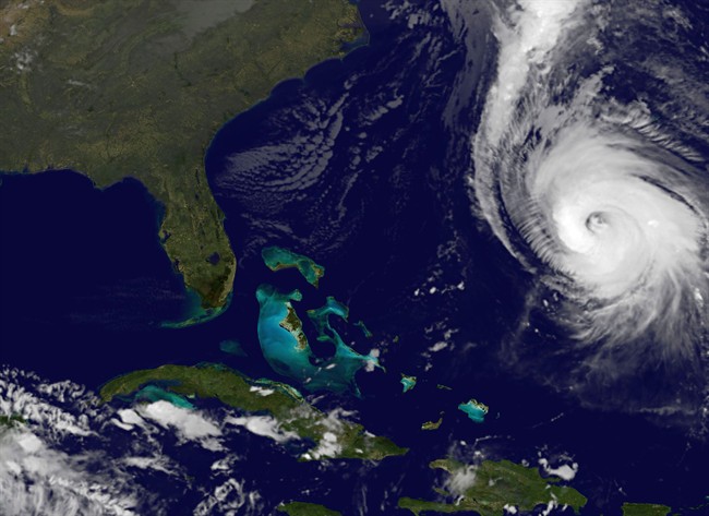 Hurricane Gonzalo, right, is pictured as it approaches Bermuda at 11:15 p.m. EDT Thursday Oct. 16, 2014.