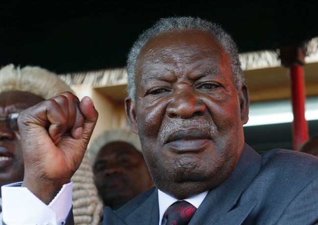 In this Sept. 23, 2011 file photo, Zambian president Michael Sata waves after taking the oath of office on the steps of the top court in Lusaka, Zambia.