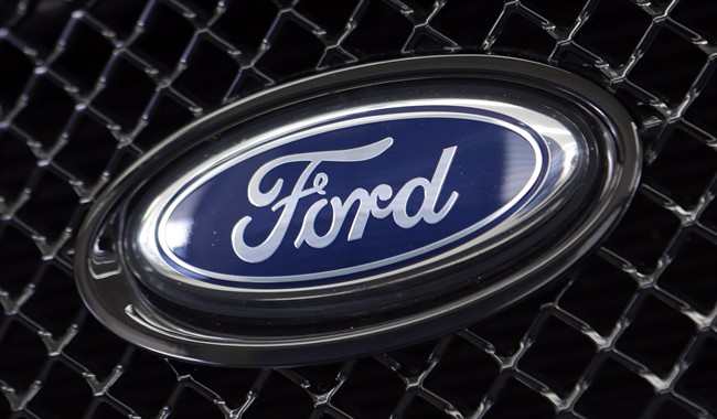 This photo taken Thursday, Aug. 21, 2014 shows the Ford logo on a vehicle at a dealership in Hialeah, Fla. 