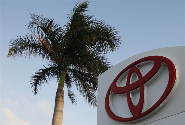 FILE - This Feb. 3, 2010 file photo shows a palm tree behind a Toyota sign at Earl Stewart Toyota in North Palm Beach, Fla. 