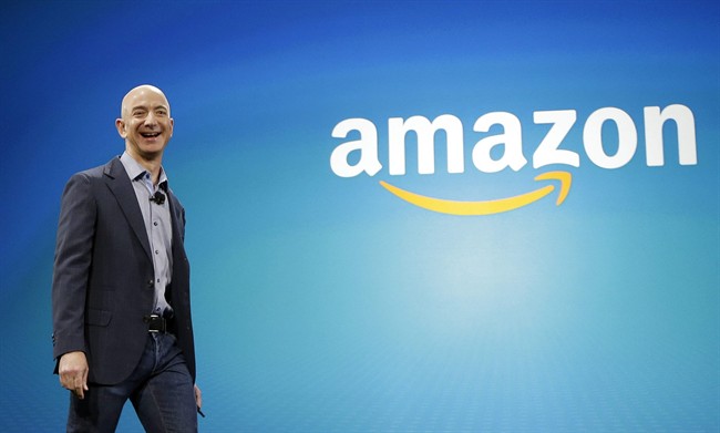 FILE - In this June 16, 2014 file photo, Amazon CEO Jeff Bezos walks on stage for the launch of the new Amazon Fire Phone, in Seattle. Amazon.com reports quarterly financial results on Thursday, Oct. 23, 2014. (AP Photo/Ted S. Warren, File).