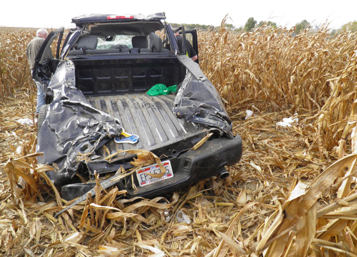 This photo provided by the Wyandot County, Ohio, Sheriff, investigators examine the wreckage of a pickup truck that crashed in a cornfield near Upper Sandusky, Ohio on Sunday, Oct. 12, 2014, killing Andrew Bloomfield and seriously injuring his wife. Bloomfield had married 37-year-old Ruth Driskill hours before the accident. A 26-year-old friend, Elizabeth Shelton, also died in the crash.