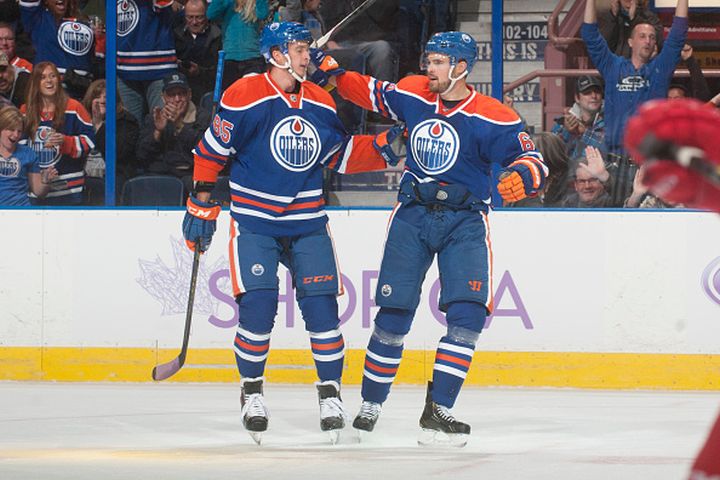 Jesse Joensuu #6 is congratulated by Martin Marincin #85 of the Edmonton Oilers after scoring a goal against the Carolina Hurricanes on October 24, 2014 at Rexall Place in Edmonton, Alberta, Canada.
