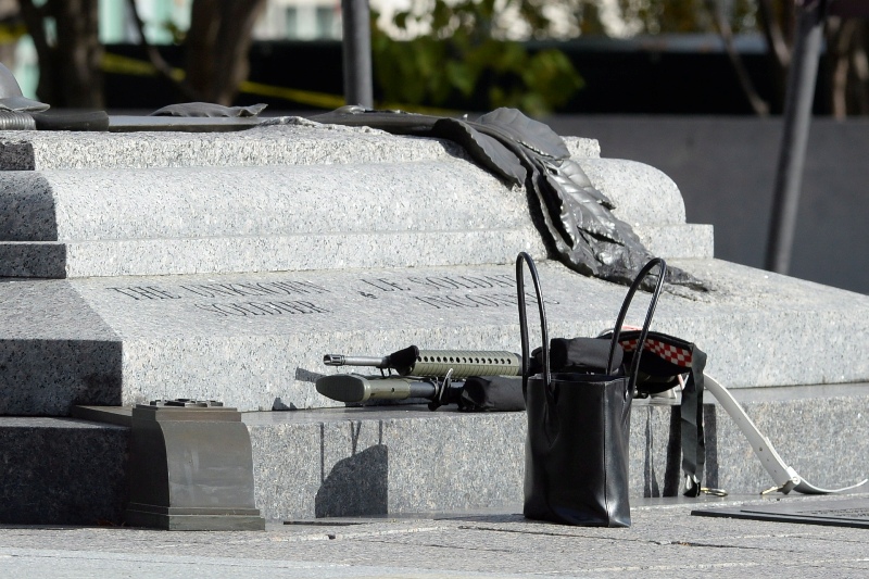 Weapons and personal belongings are pictured at the National War Memorial as police secure the area near Parliament Hill in Ottawa on Wednesday Oct.22, 2014. 