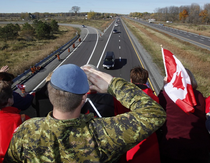 A Canadian Soldier salutes the hearse carrying the body of Cpl. Nathan Cirillo on the Veterans Memorial Highway in Ottawa on Friday, October 24, 2014.
