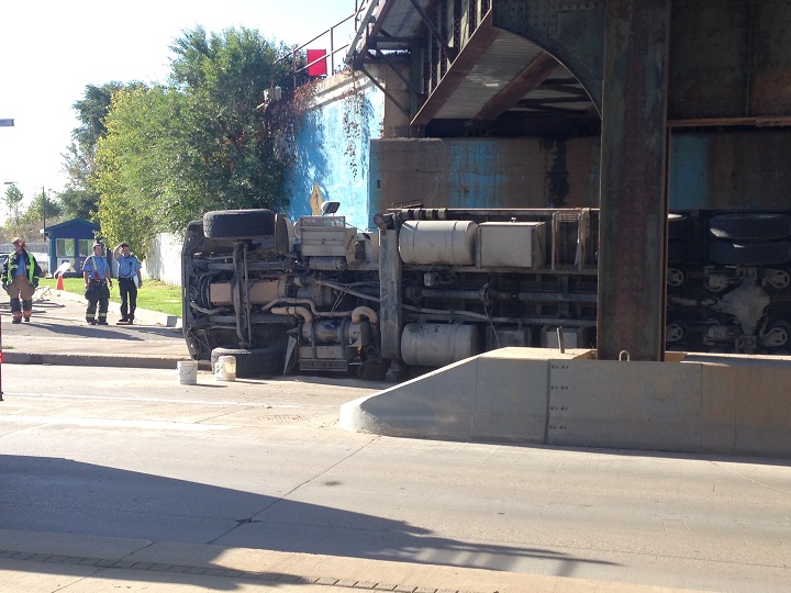 Truck on its side under bridge on William Stephenson Way in Winnipeg on Thursday, Oct. 2, 2014.