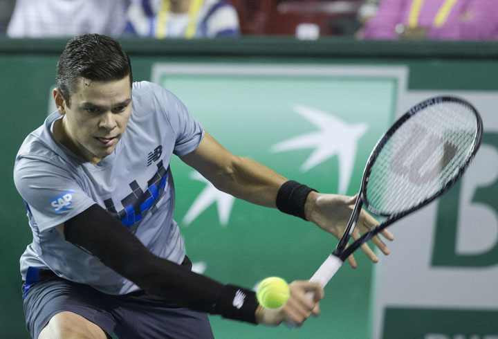 Milos Raonic returns the ball to Roberto Bautista during their third round match at the ATP World Tour Masters tennis tournament at Bercy stadium in Paris, France, Thursday, Oct. 30, 2014.