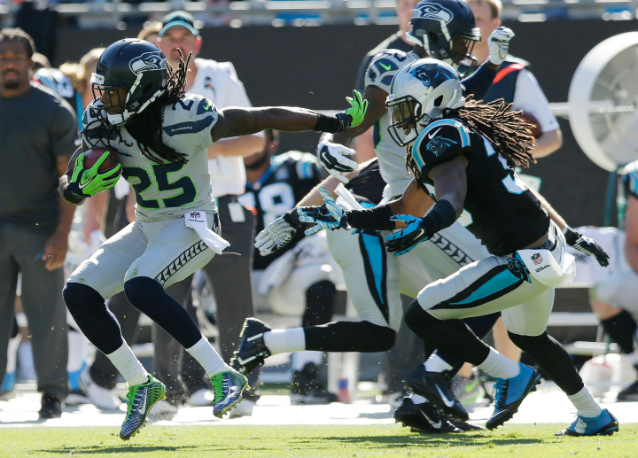  Seattle Seahawks cornerback Richard Sherman (25) returns a punt against the Carolina Panthers during the second half of an NFL football game, Sunday, Oct. 26, 2014, in Charlotte. 