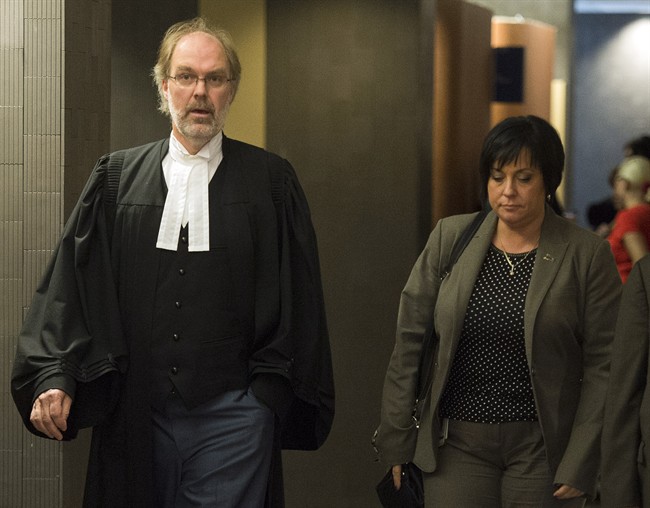 Crown prosecutor Louis Bouthillier, left, leaves the courtroom as the Crown wraps up its case at the murder trial for Luka Rocco Magnotta Tuesday, Oct. 28, 2014 in Montreal. 