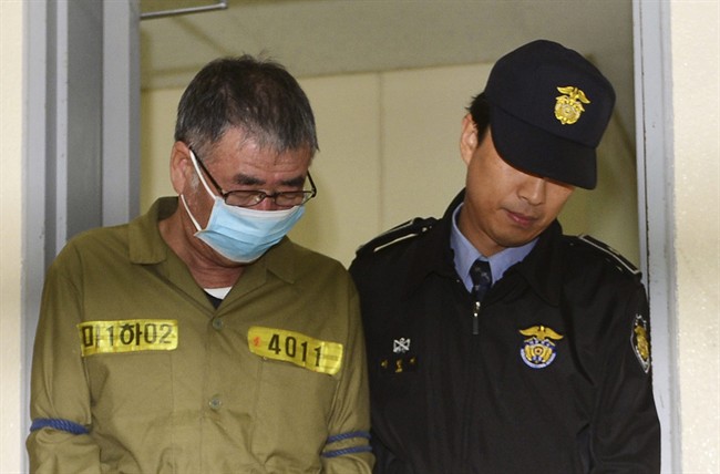 Lee Joon-seok, the captain of the sunken South Korean ferry Sewol, left, arrives at Gwangju District Court in Gwangju, South Korea, Monday, Oct. 27, 2014. 
