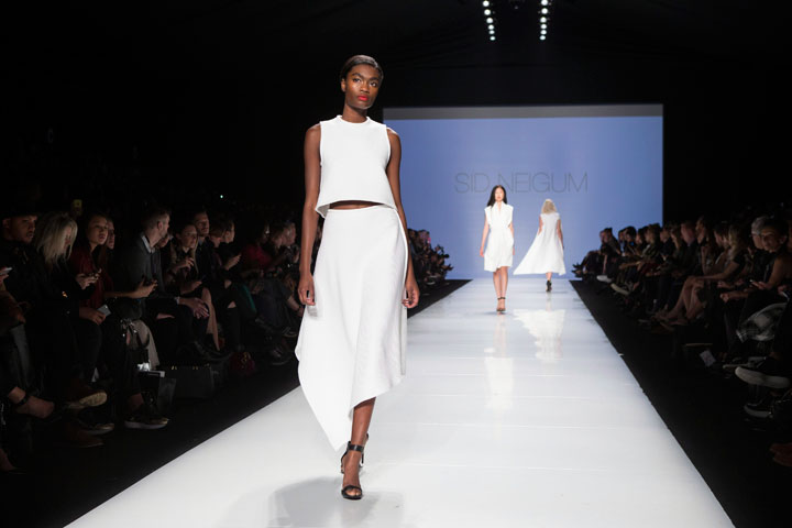 A model takes to the runway while showing a creation by Sid Neigum, the winner of the Mercedes-Benz Start Up show, during Toronto Fashion Week in Toronto on Monday, October 20, 2014.