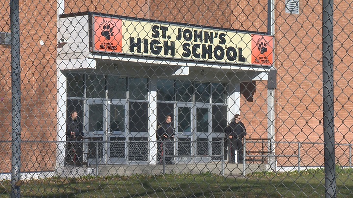 Police on guard at St. John's High School in Winnipeg on Tuesday, October 21, 2014.